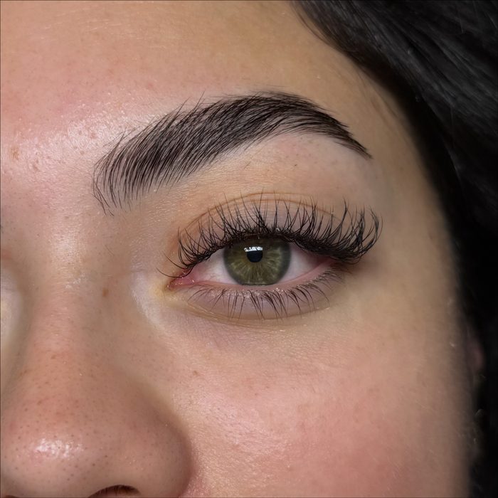 Lashes being brushed through with a spoolie